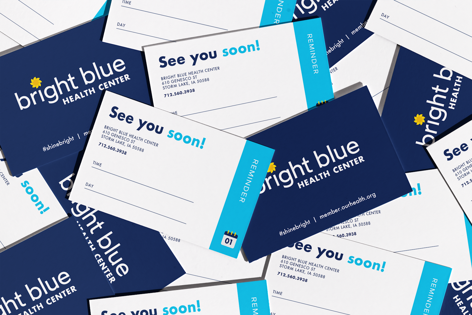 The Bright Blue brand design appointment card in a pile of cards.