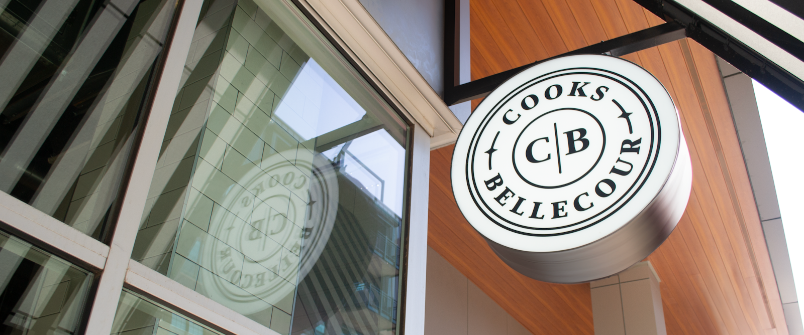 A Cooks | Bellecour logo mark on a storefront sign.