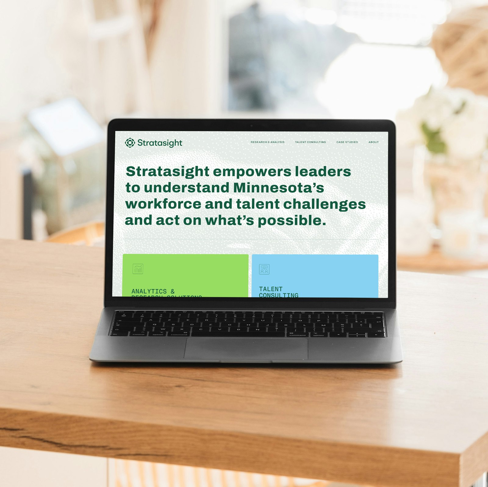 Stratasight laptop: The Stratasight brand identity, developed by Capsule in Stratasight's 2026 rebrand, displayed on a laptop. Text reads: "Stratasight empowers leaders to understand Minnesota's workforce and talent challenges and act on what's possible."