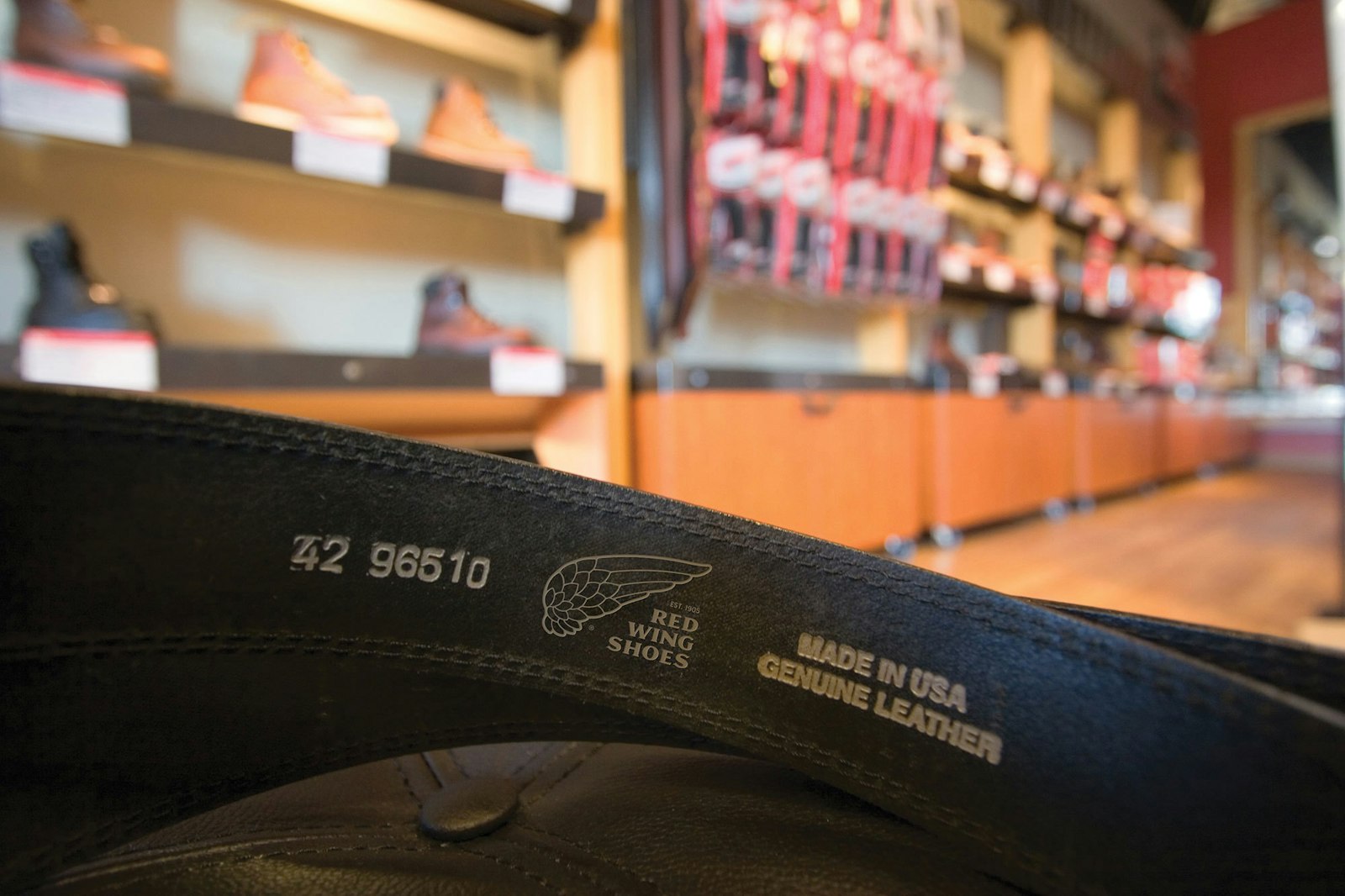 The Red Wing Shoes brand design logo on the inside of a belt.