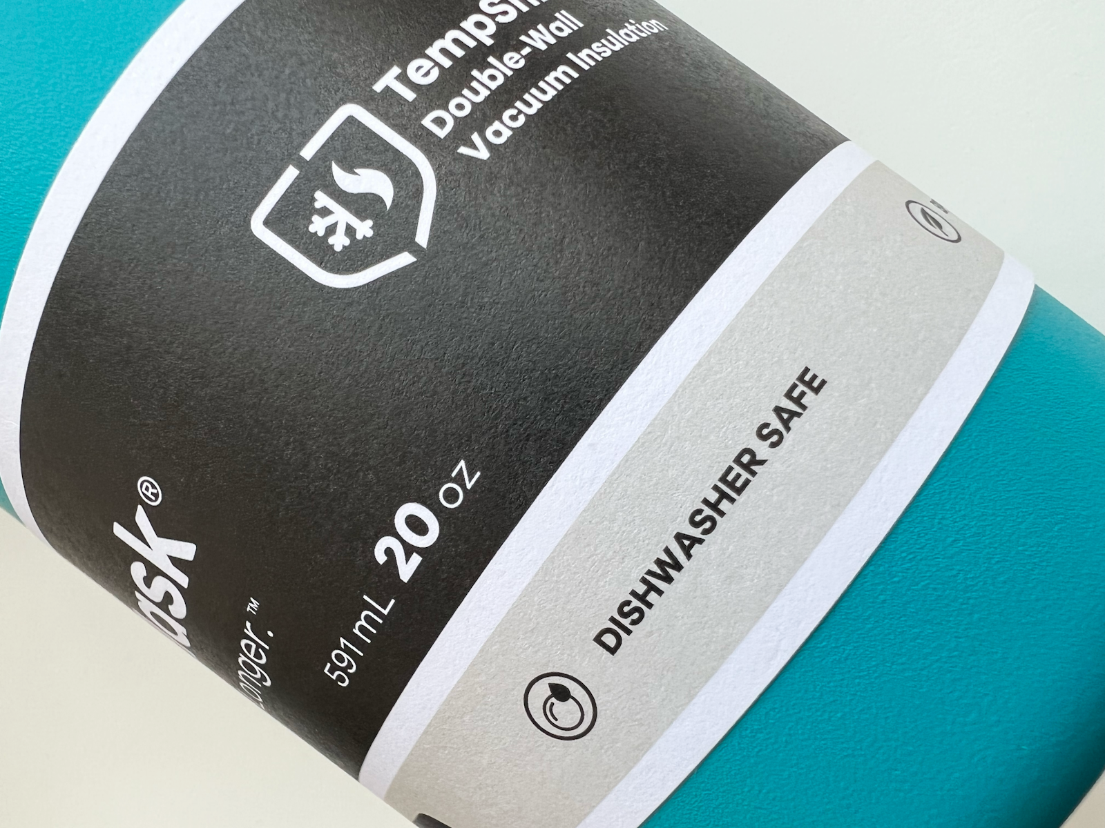The Hydro Flask brand design label packaging on closeup of green flask.