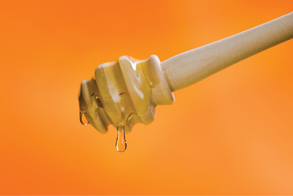 The Cargill Likewise brand name design with honey tool dripping with honey.