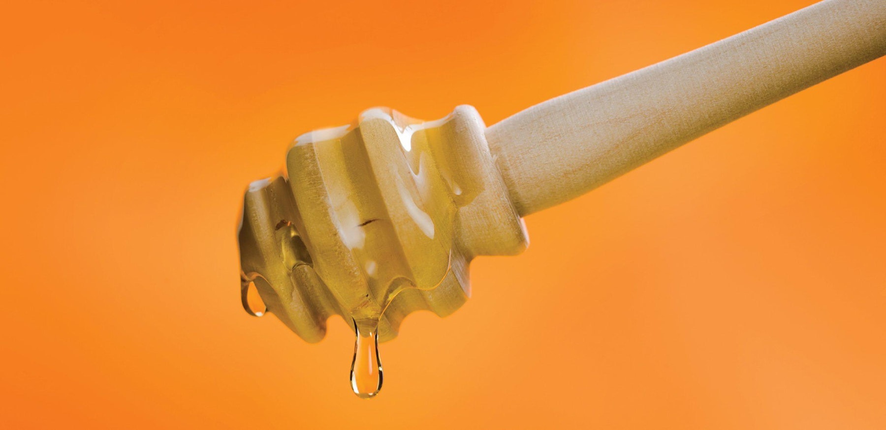 The Cargill Likewise brand name design with honey tool dripping with honey and orange background.