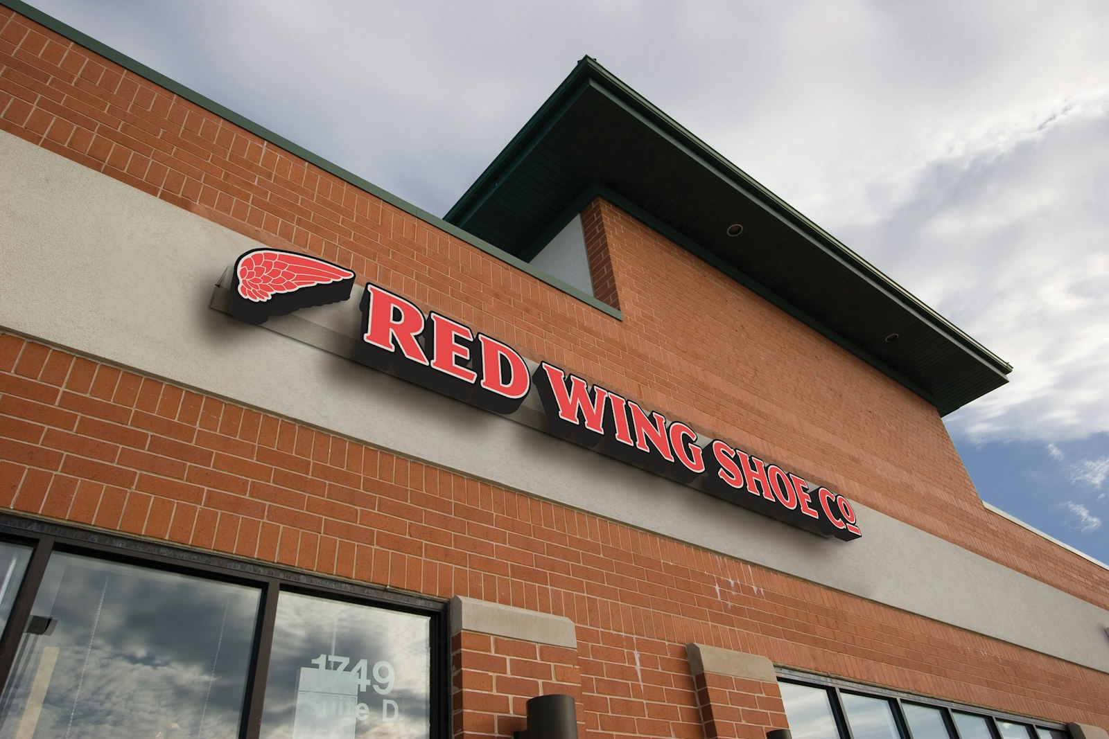 The Red Wing Shoes brand design logo on retail signage outside.