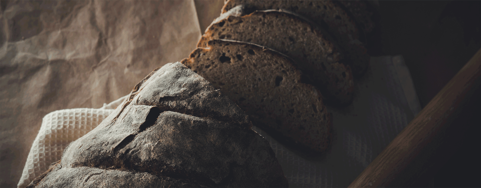 A cut loaf of bread for savor crafted bread branding and promotions.