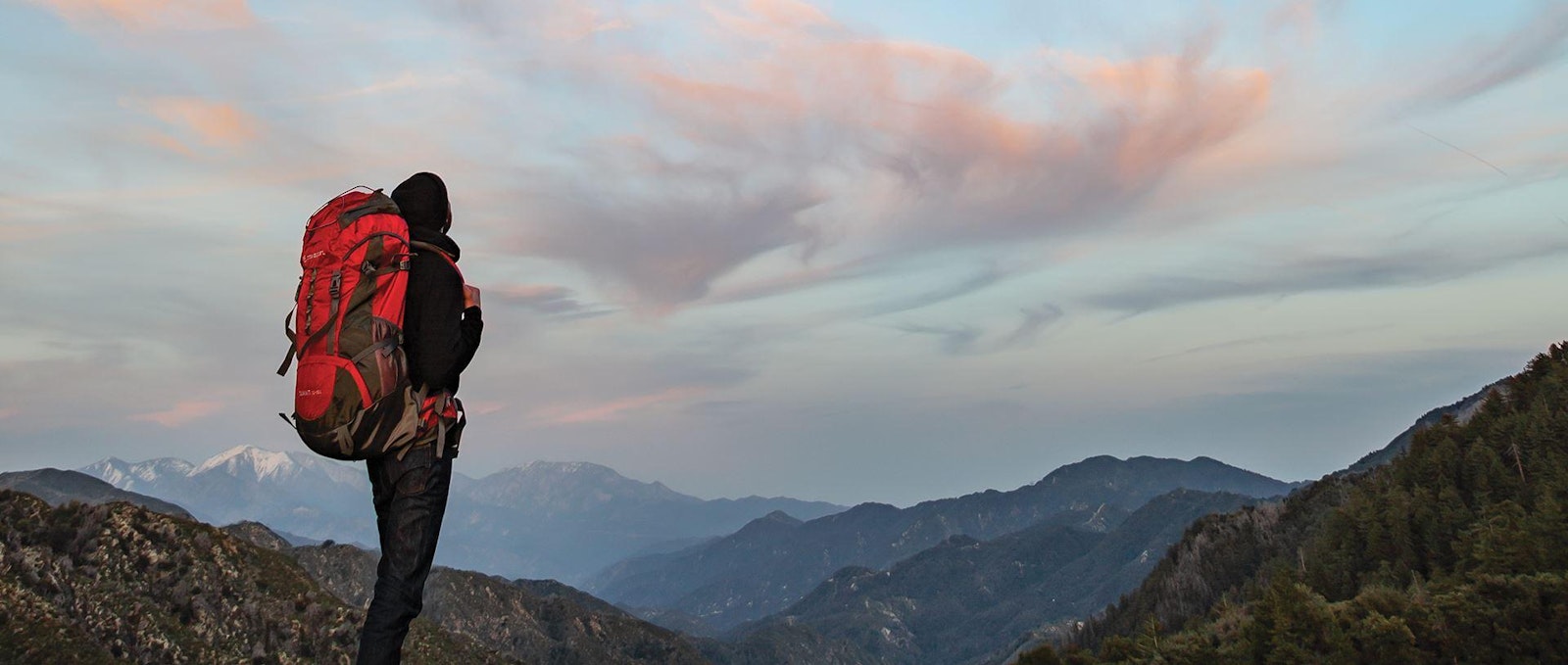 The Stansport brand logo and packaging design photo of person with backpack looking to horizon.