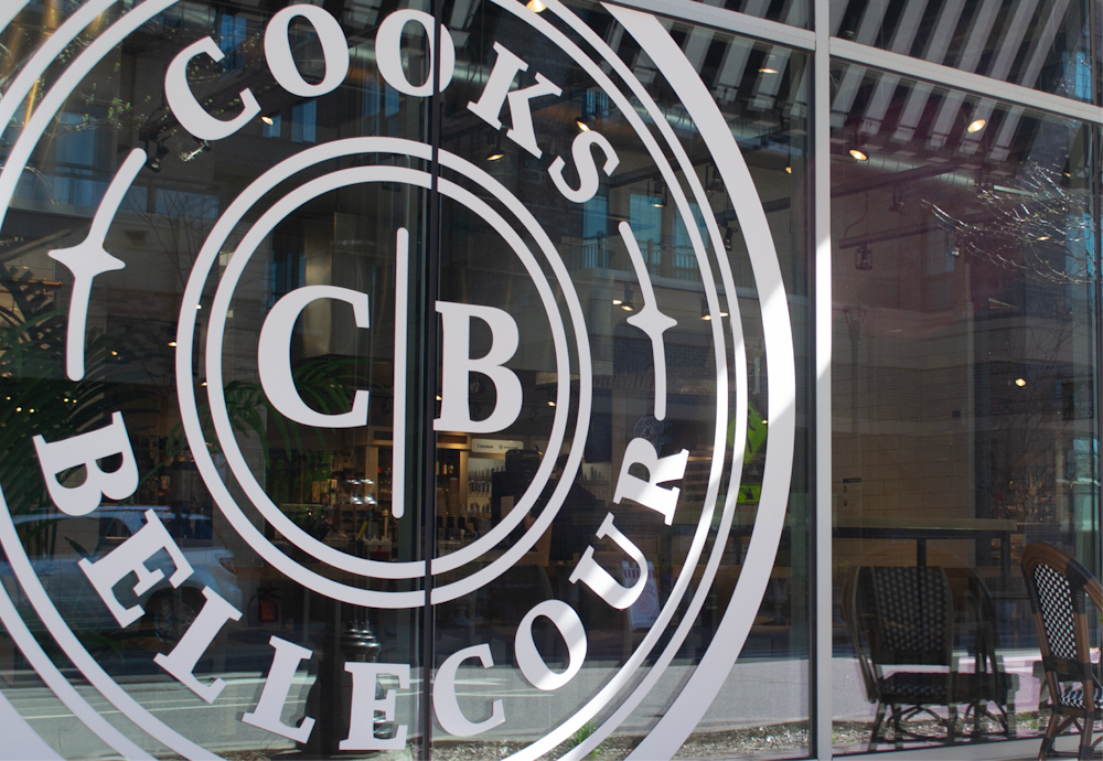 The Cooks Bellecour brand design logo on a window of the store.