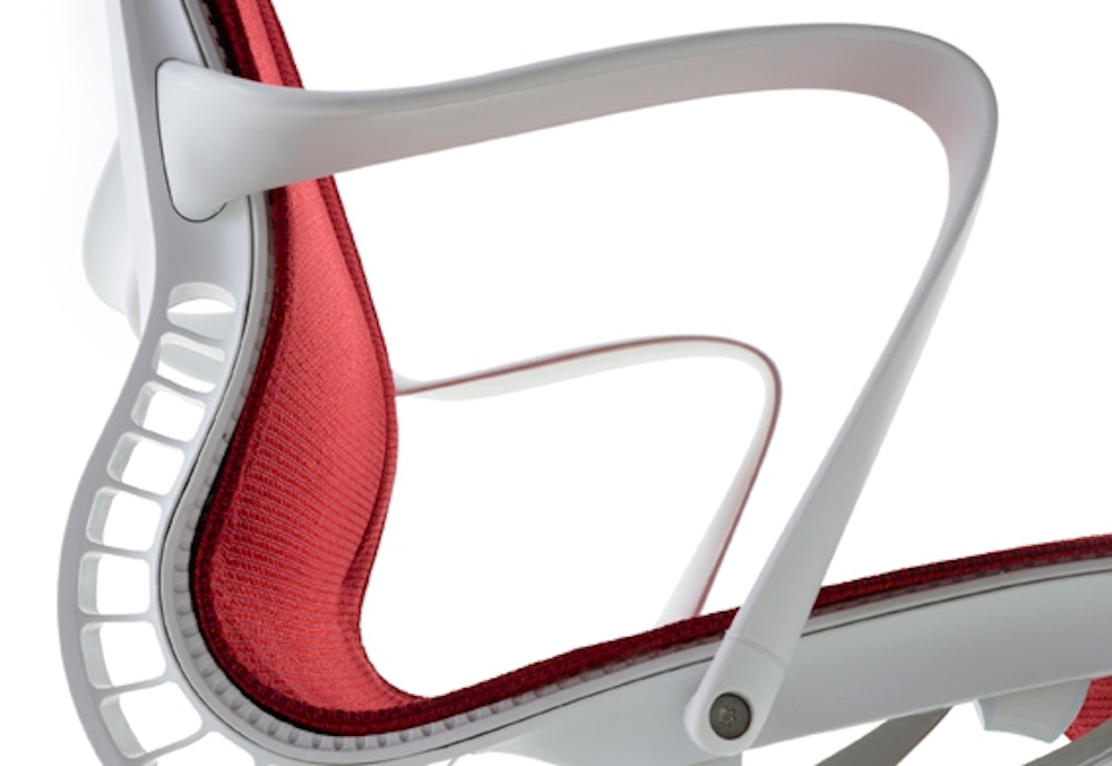 The Miller Knoll brand Setu chair design side view with red seat and white frame.